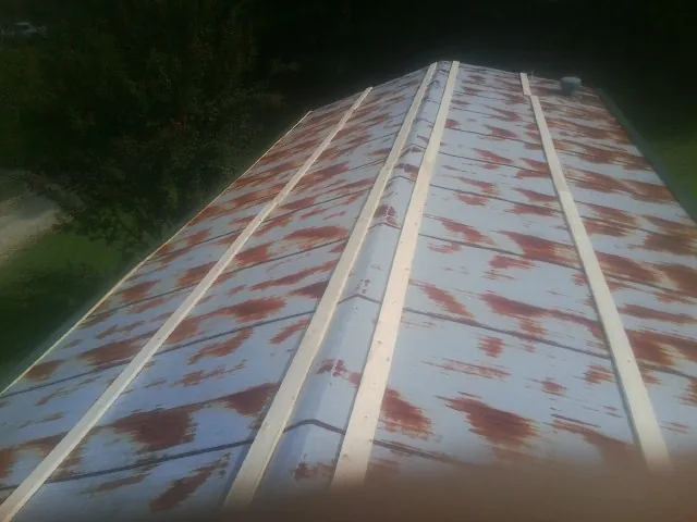 Rusted metal roof panels with new wood purlins before replacement — Storm Damage Roof Repair in Neeses by Roofing Brothers