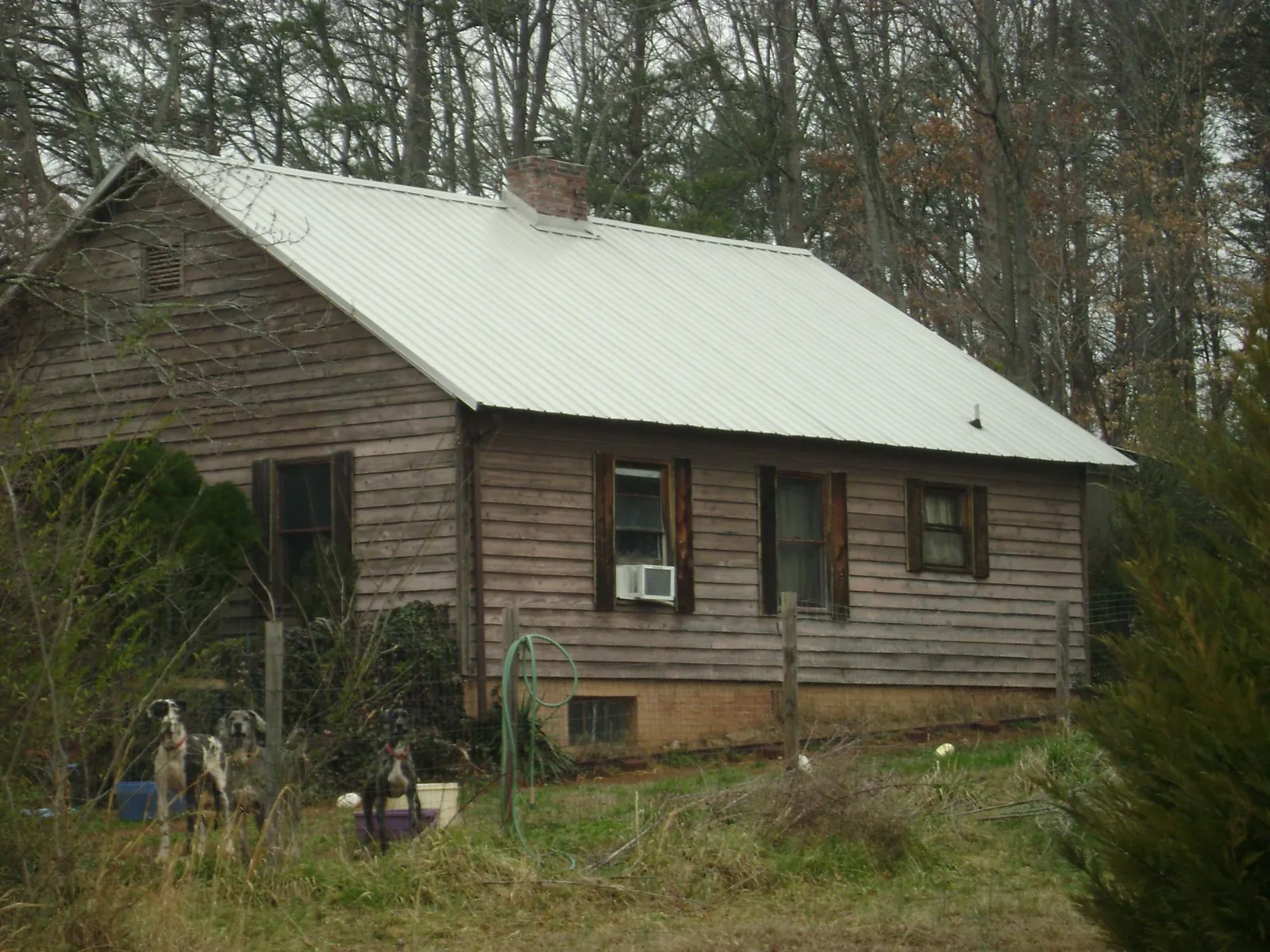 White metal roof on an old wood sided farmhouse, from a Metal Roof Installation job in Neeses
